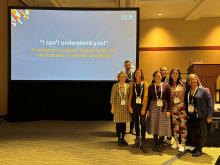 group of people in front of a projected slide