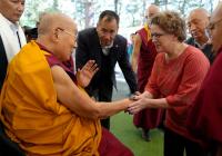 Professor Emily Bender shakes hands with the Dalai Lama