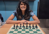 Photo of a woman in front of a chess board