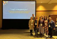 group of people in front of a projected slide