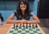 Photo of a woman in front of a chess board