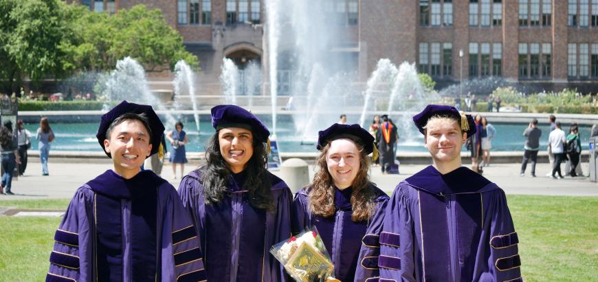 Four graduate students standing in front of Drumheller Fountain: Siyu Liang, Saiya Layana Karamali, Elizabeth C. Conrad, and Raymond Gagne.
